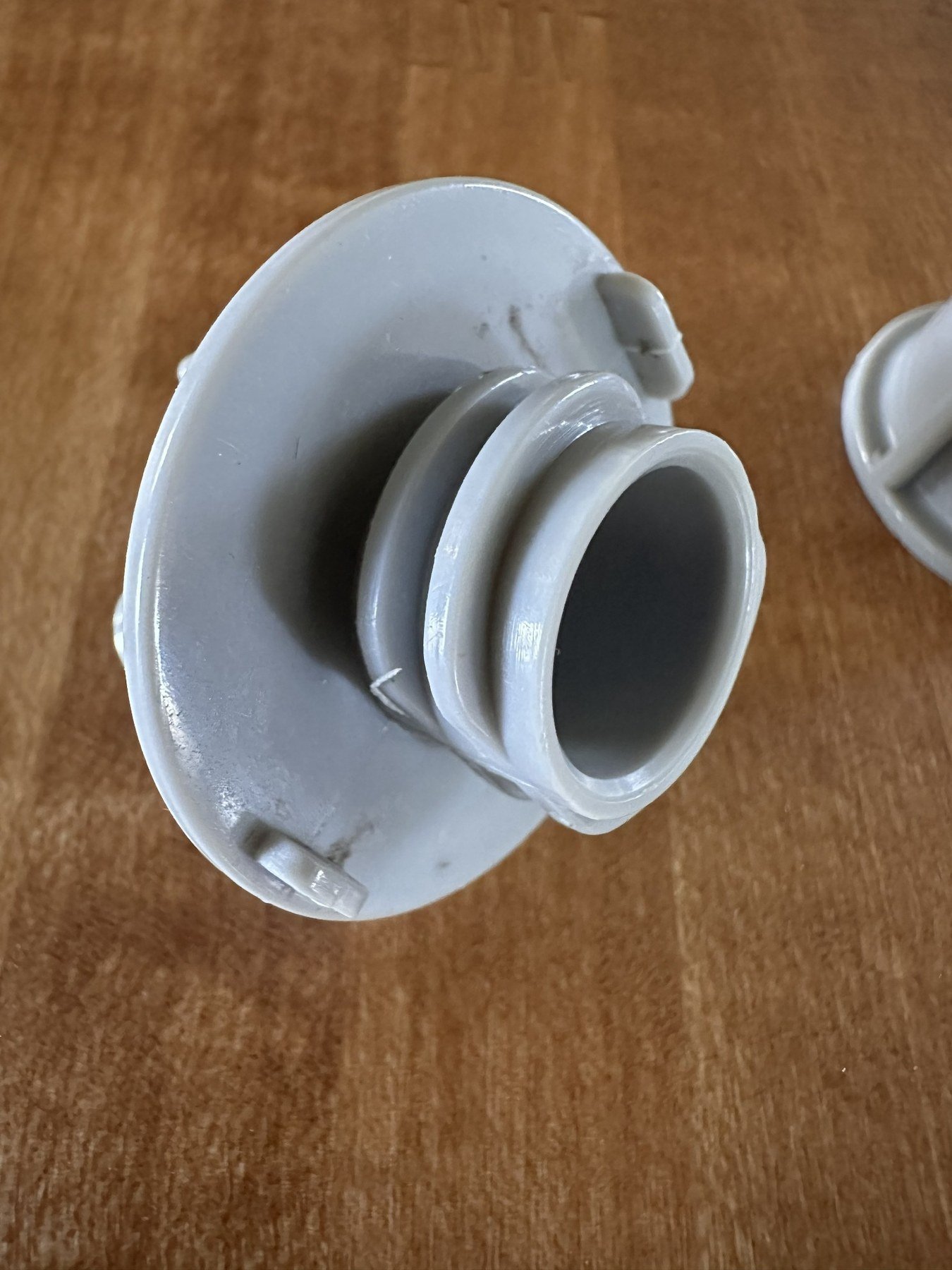 Close view of the underside of the gray upper dispenser