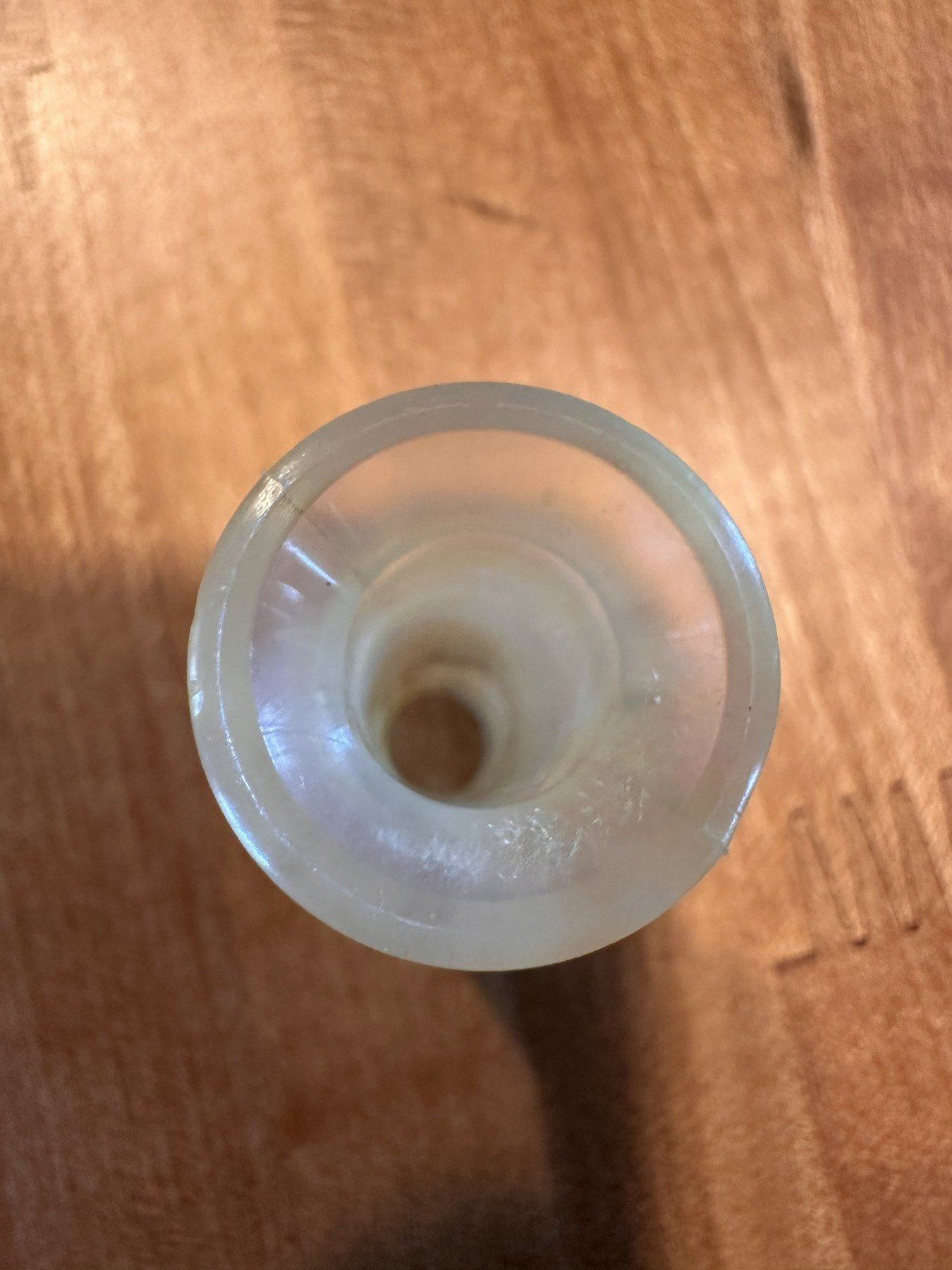 Close view of the wide flared end of the translucent outlet stem