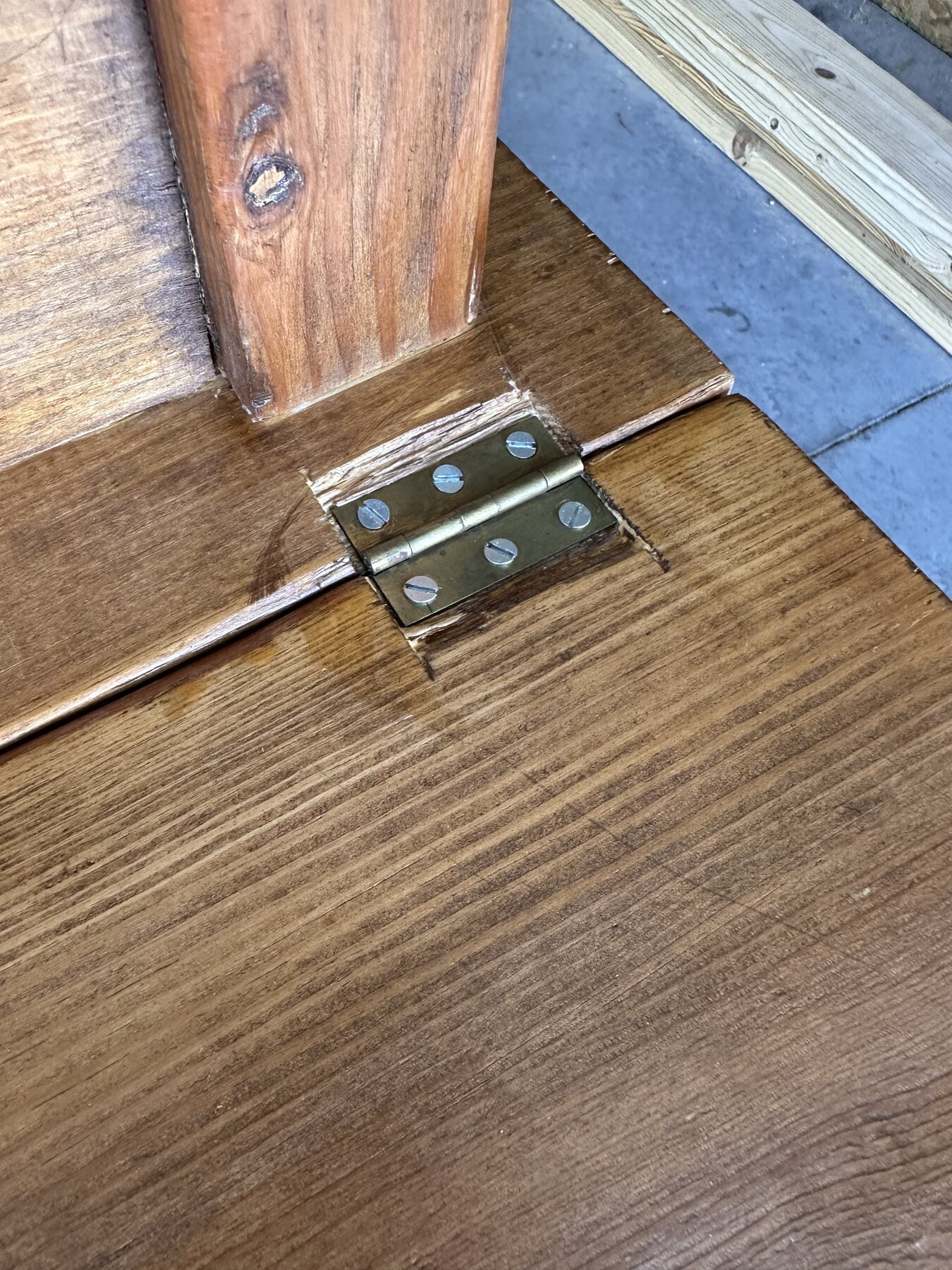 Second recessed drop-leaf hinge beside a table leg with wear around its mortise