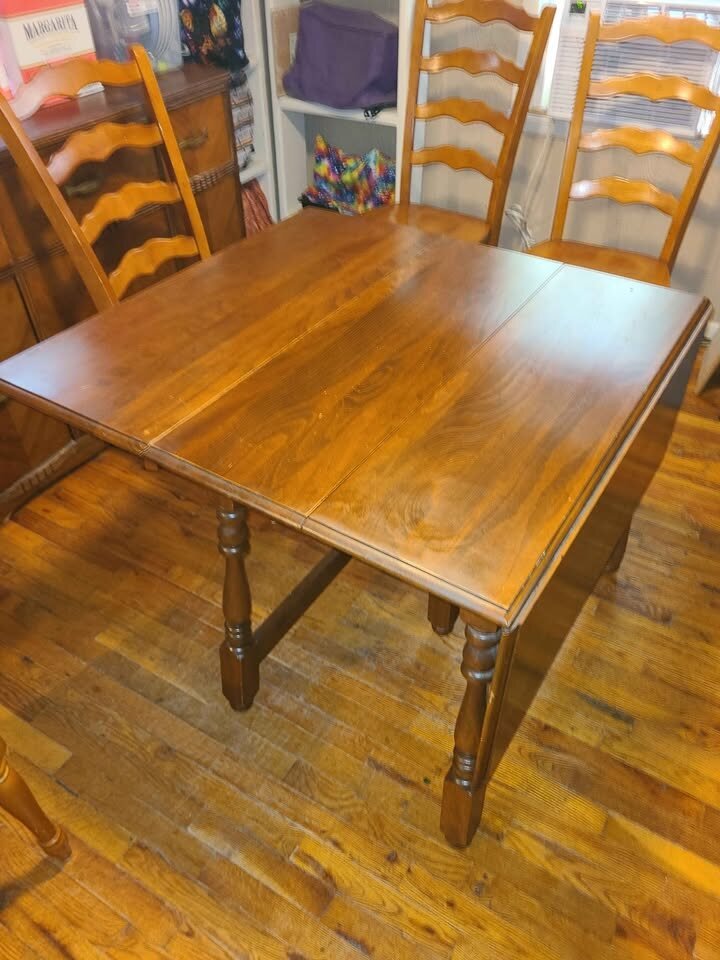 Marketplace drop-leaf table shown fully open with a warm brown finish