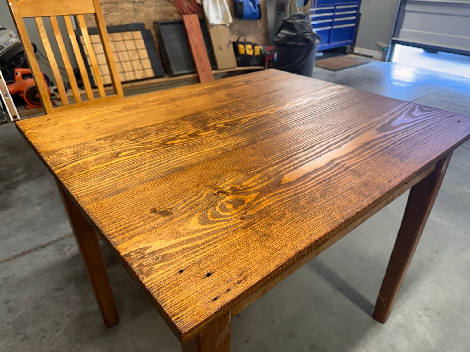 Angled overall view of the warm brown tabletop after its second polyurethane coat