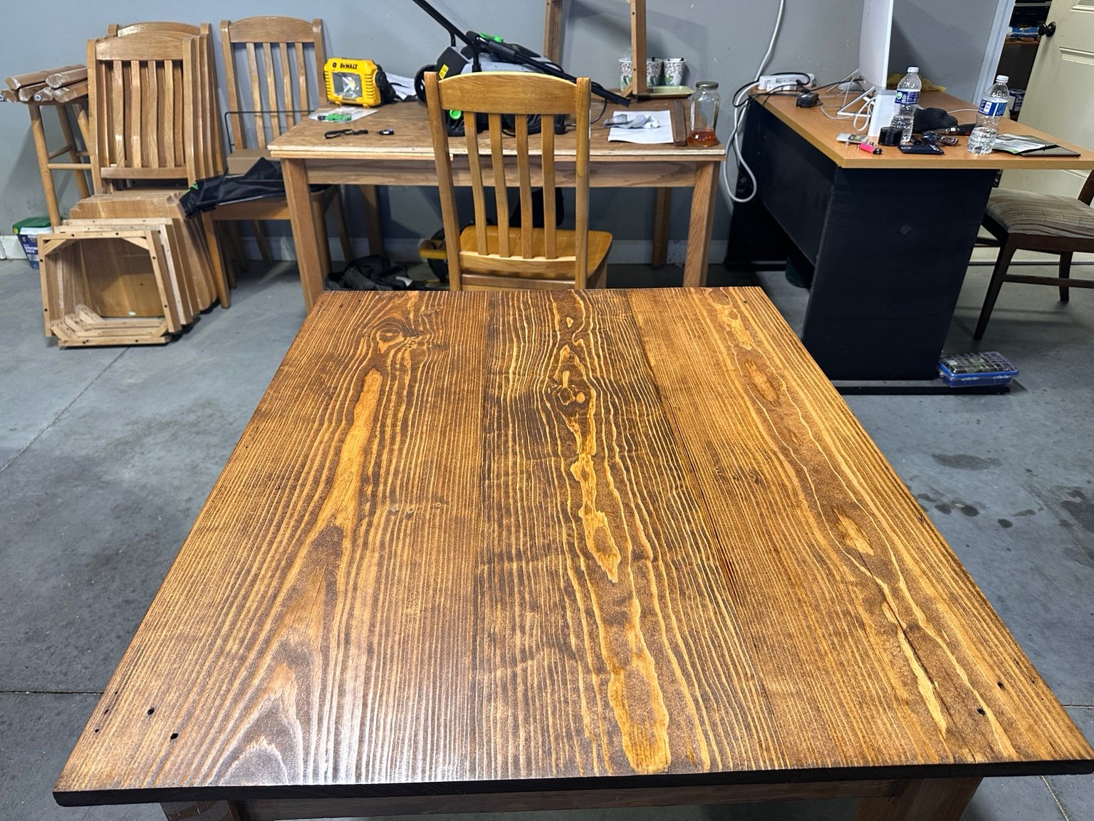 Head-on workshop view across the tabletop after the third polyurethane coat
