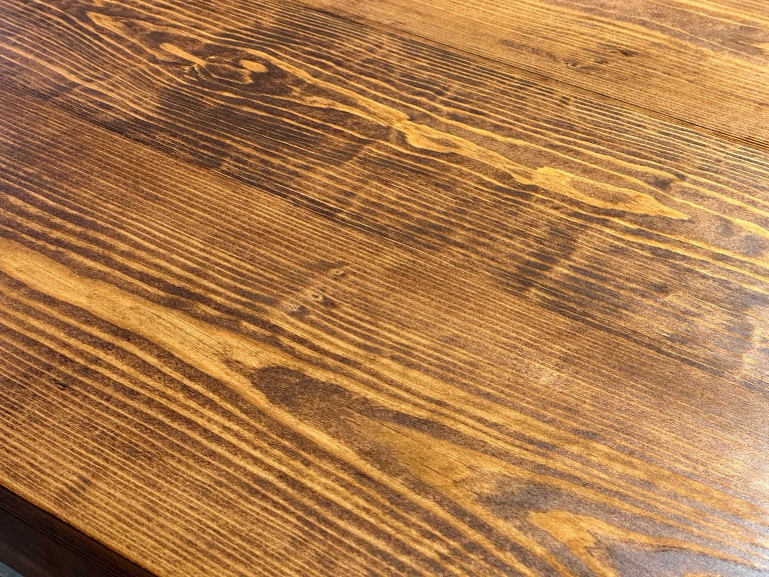 Second close surface study showing contrasting dark and amber grain beneath coat four