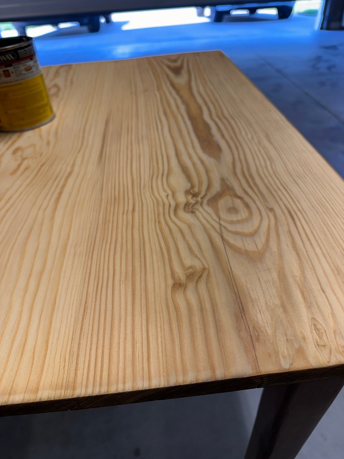 Lengthwise view of pale tabletop grain with the stain can at the upper left