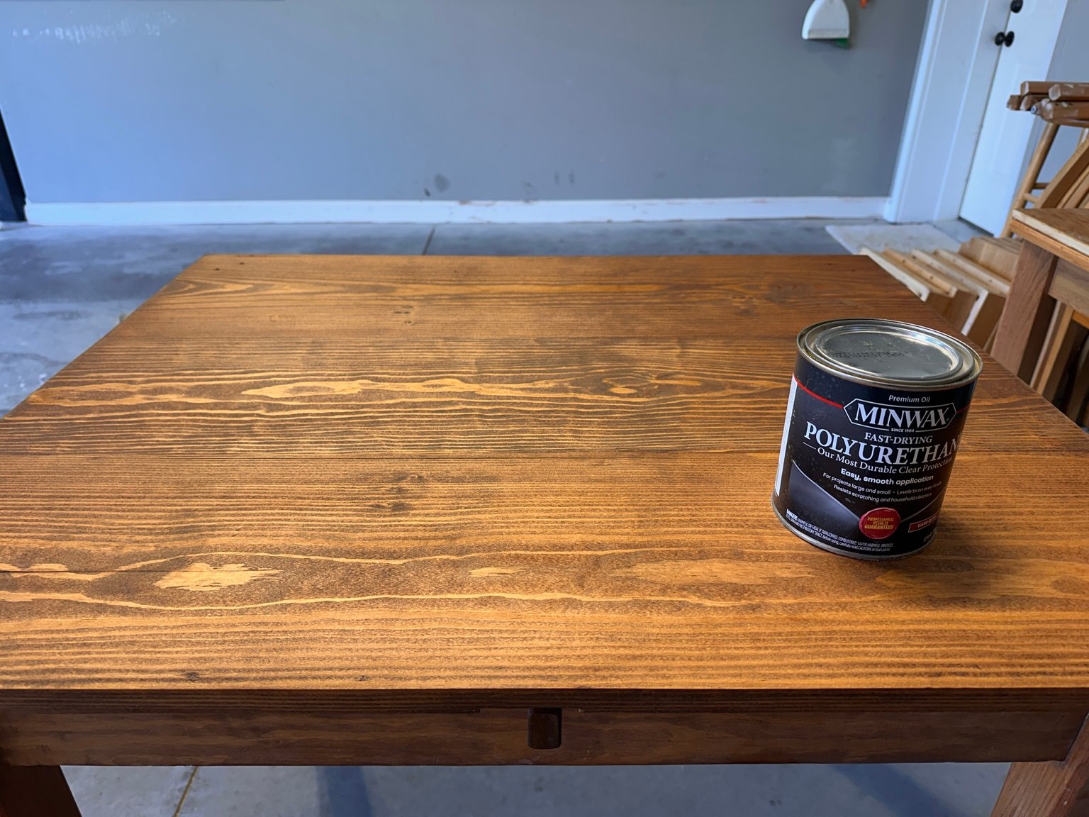 Stained tabletop with the polyurethane can at its right side before the first-coat photo sequence