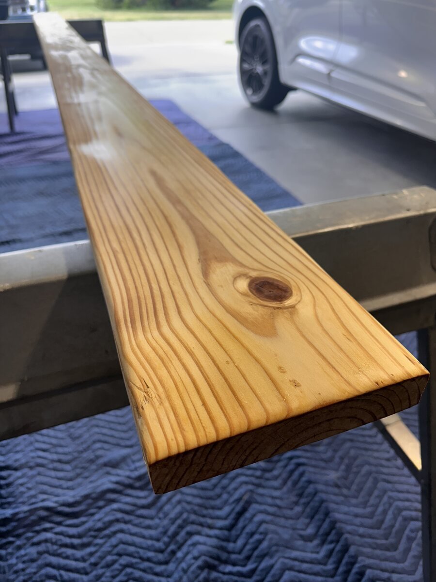 Rich amber grain and knot after the first coat