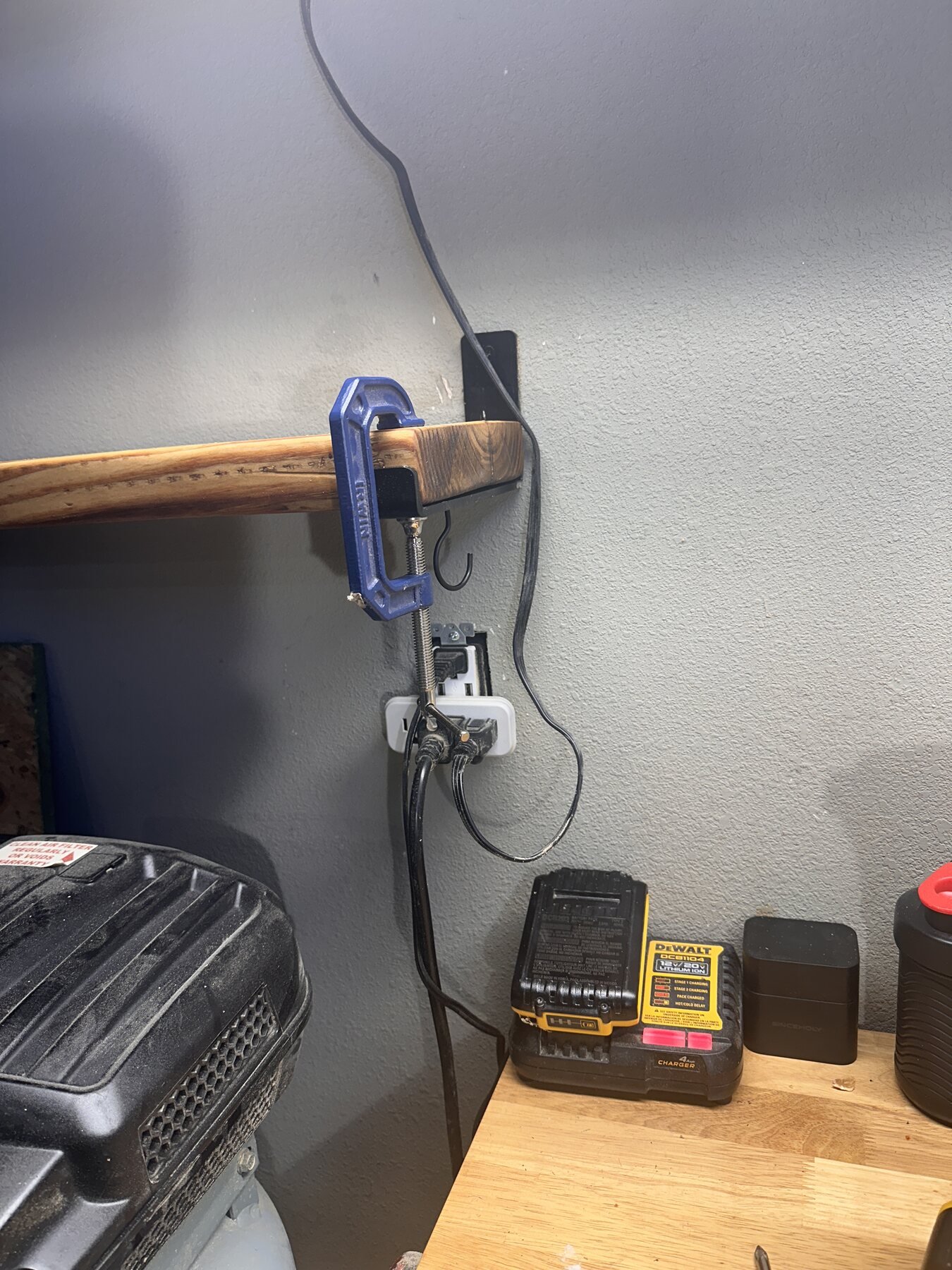 Clamp holding the end of the finished shelf near an outlet