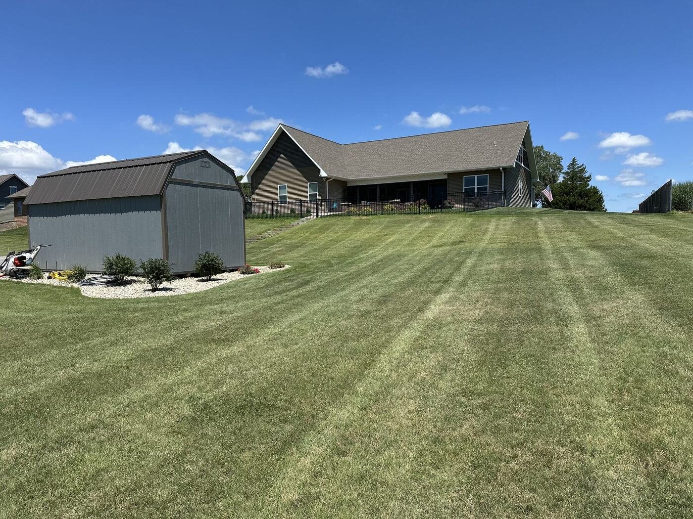 Landscaped shed with the house on the hill behind it