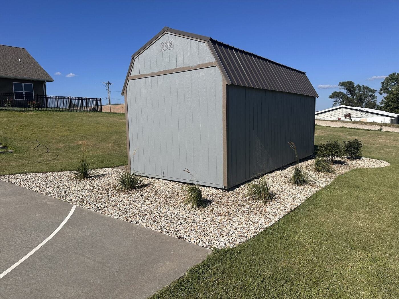 Landscaped shed surrounded by ornamental grasses and shrubs